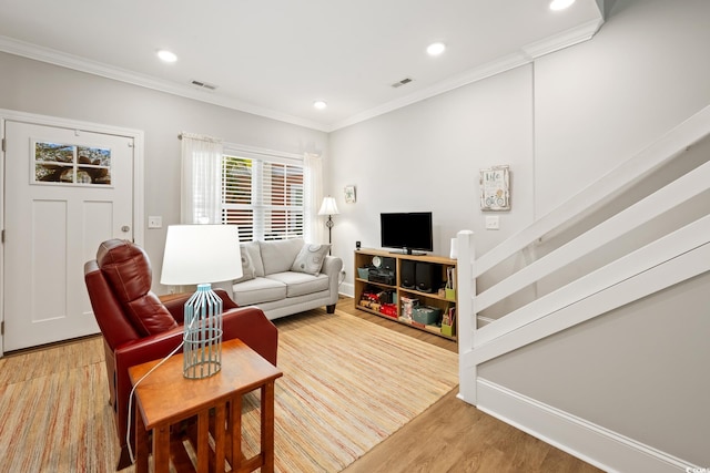 living room featuring hardwood / wood-style floors and crown molding