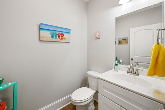 bathroom featuring vanity, hardwood / wood-style floors, and toilet