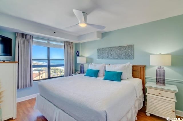 bedroom with wood finished floors, baseboards, and ceiling fan