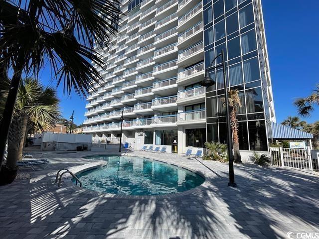 community pool with a patio area