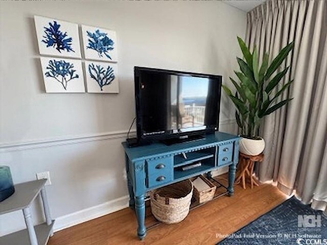 living area featuring wood finished floors and baseboards