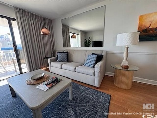 living room with baseboards and wood finished floors