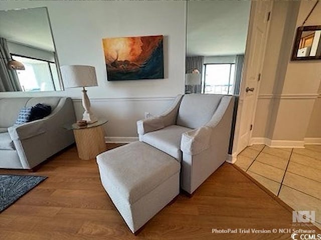 living area with wood finished floors and baseboards