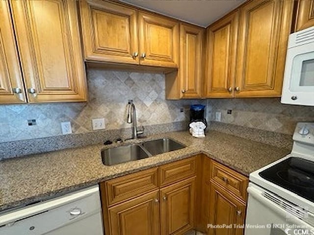 kitchen with backsplash, brown cabinets, white appliances, and a sink