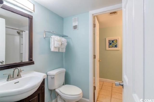 full bathroom with tile patterned flooring, toilet, vanity, and baseboards