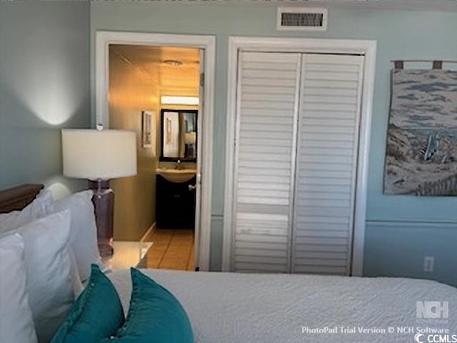 bedroom with visible vents and a closet