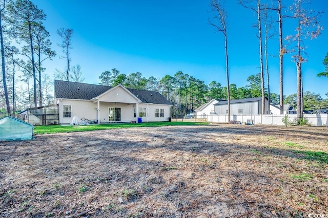 rear view of house with a yard