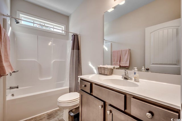 full bathroom with shower / tub combo with curtain, vanity, and toilet