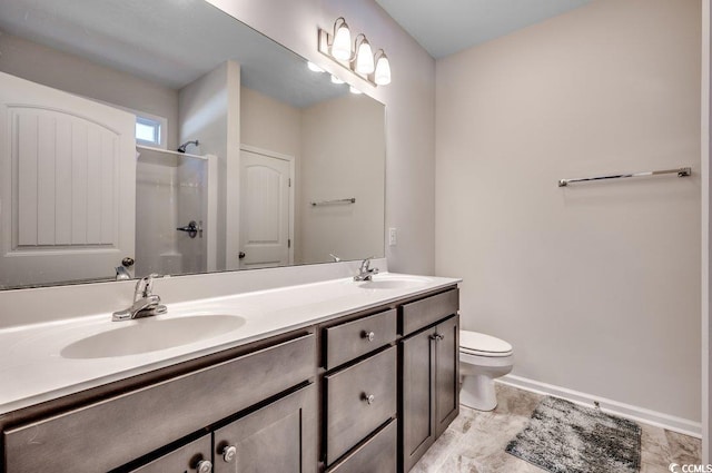 bathroom featuring vanity, toilet, and walk in shower