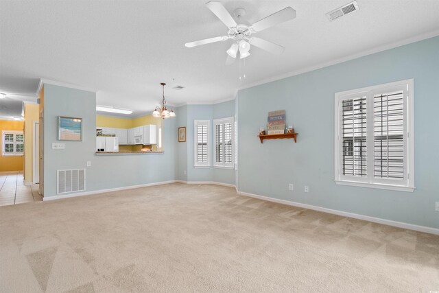 1529 Lanterns Rest Dr Unit 201, Myrtle Beach, SC 29579 - unfurnished living room with crown molding, light carpet, a chandelier, baseboards, and a ceiling fan
