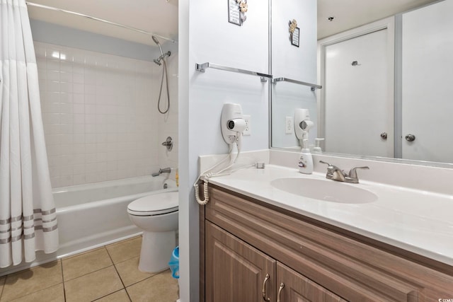 full bathroom featuring tile patterned floors, shower / bath combo with shower curtain, vanity, and toilet