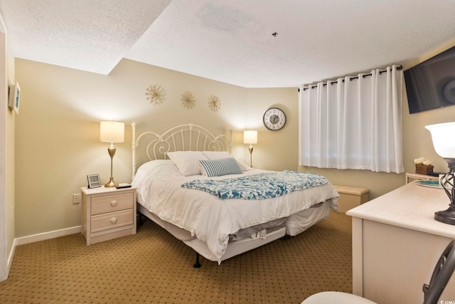 bedroom featuring a textured ceiling and light colored carpet