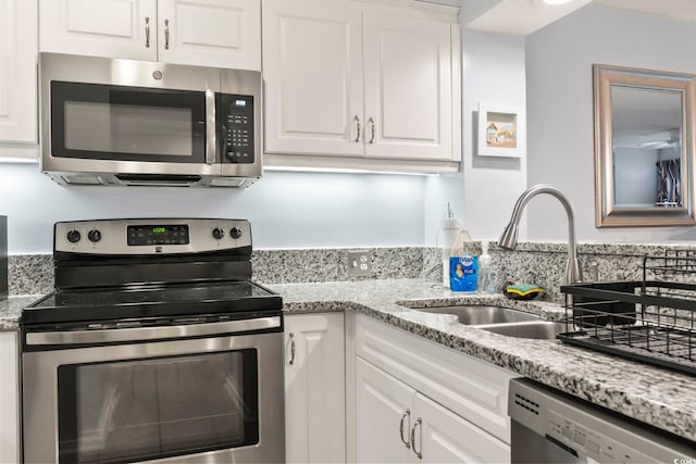 kitchen with sink, stainless steel appliances, and white cabinetry