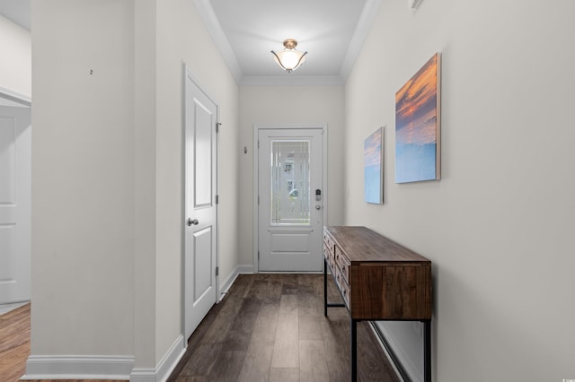 entryway featuring dark wood-style floors, baseboards, and ornamental molding