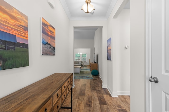 corridor with dark wood-style floors, baseboards, and ornamental molding