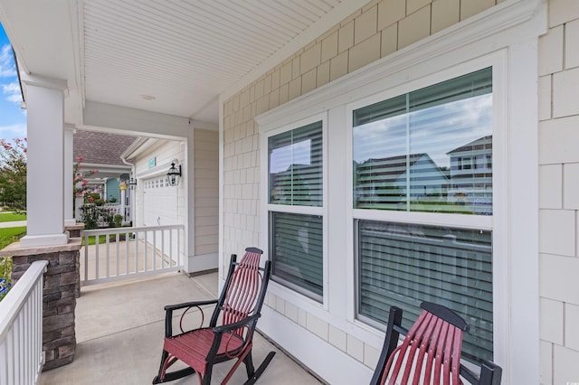 view of patio featuring a garage and a porch