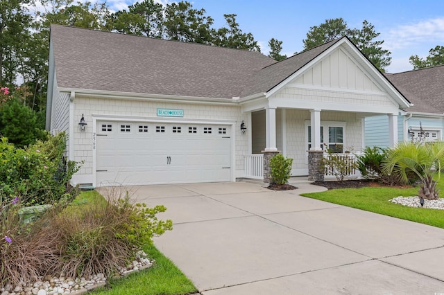 view of front of property featuring a shingled roof, concrete driveway, an attached garage, a porch, and board and batten siding