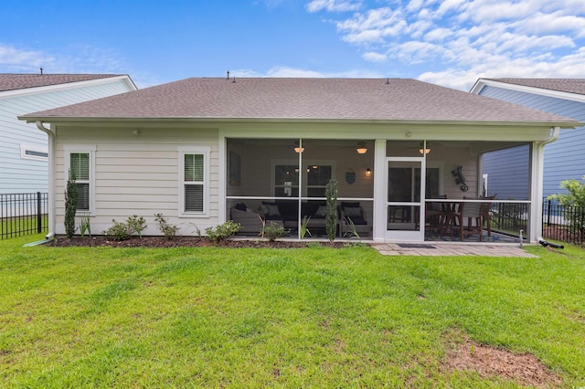 back of house featuring a patio, a shingled roof, a lawn, a sunroom, and fence