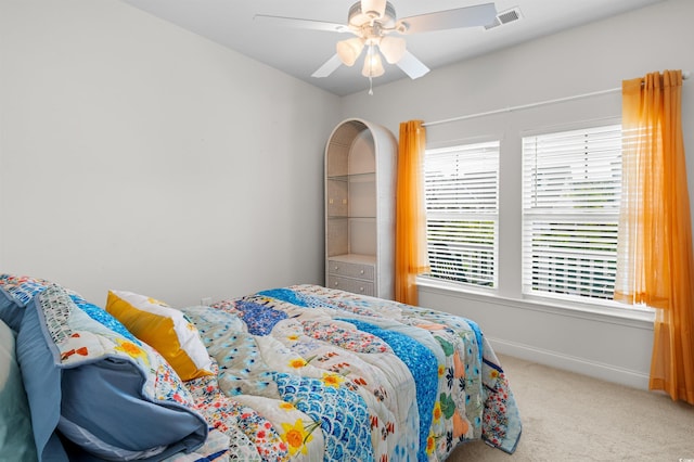 carpeted bedroom with baseboards, visible vents, and ceiling fan