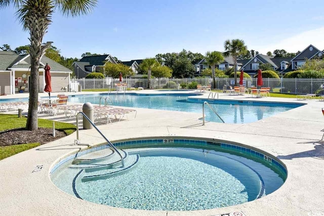 view of pool featuring a community hot tub and a patio