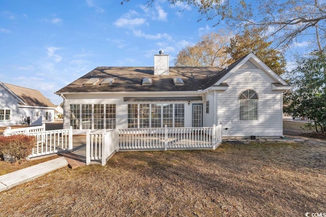 back of property with a lawn