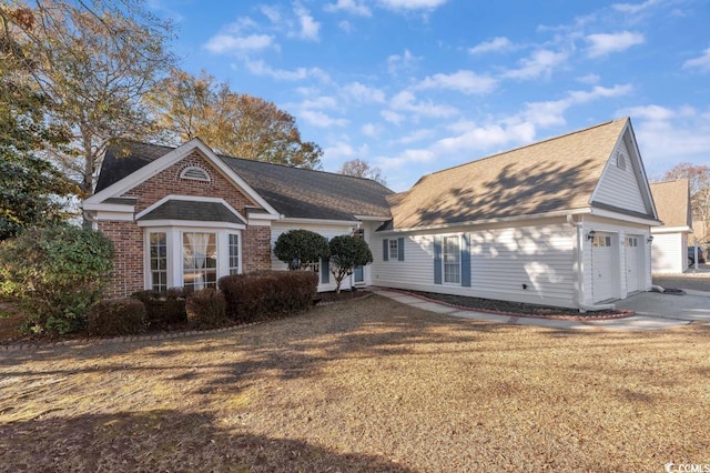 view of front of property with a garage and a front yard