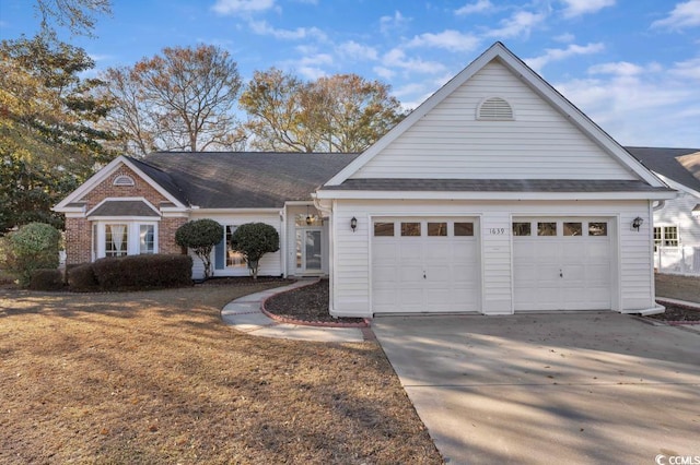 1639 Coventry Rd, Surfside Beach, SC 29575 - traditional-style home featuring an attached garage, driveway, and roof with shingles