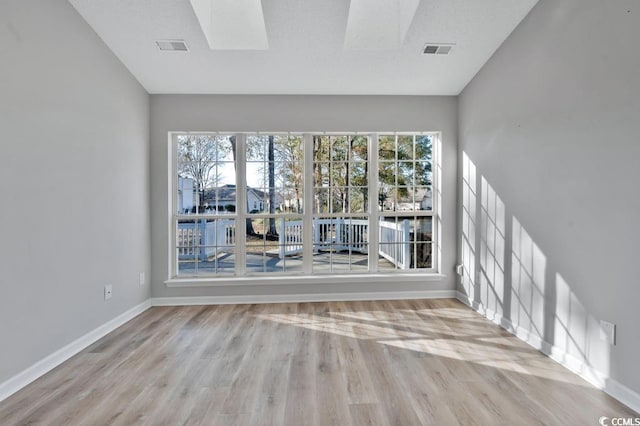 spare room with light hardwood / wood-style floors