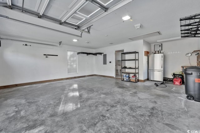 garage with stainless steel fridge and electric panel
