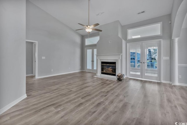 1639 Coventry Rd, Surfside Beach, SC 29575 - unfurnished living room featuring high vaulted ceiling, a ceiling fan, light wood finished floors, a premium fireplace, and baseboards