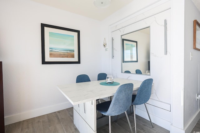 dining space with wood-type flooring