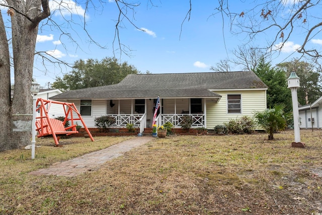 view of front of home with covered porch and a front yard