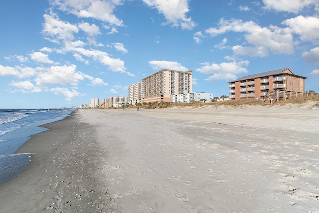 view of property featuring a beach view and a water view