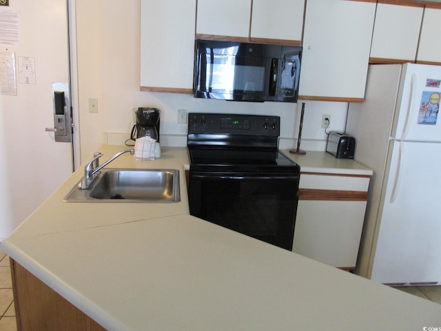 kitchen featuring black appliances, white cabinets, light countertops, and a sink