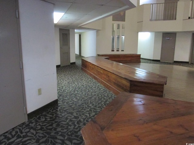 hallway featuring a drop ceiling