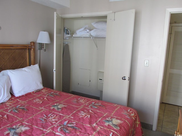 tiled bedroom featuring a closet