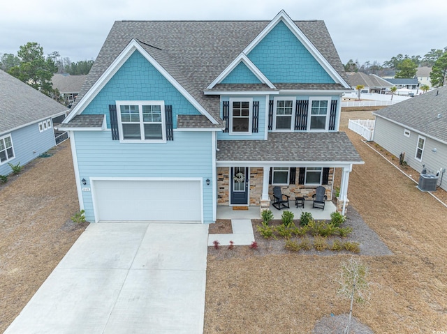 craftsman house featuring central AC, a garage, and a porch