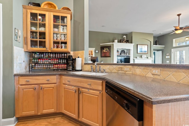 kitchen featuring tasteful backsplash, dishwasher, ceiling fan, sink, and kitchen peninsula