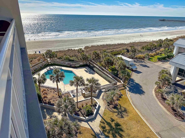 birds eye view of property with a water view and a view of the beach