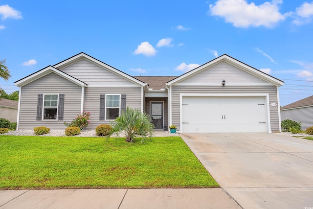 ranch-style house featuring a front yard and a garage