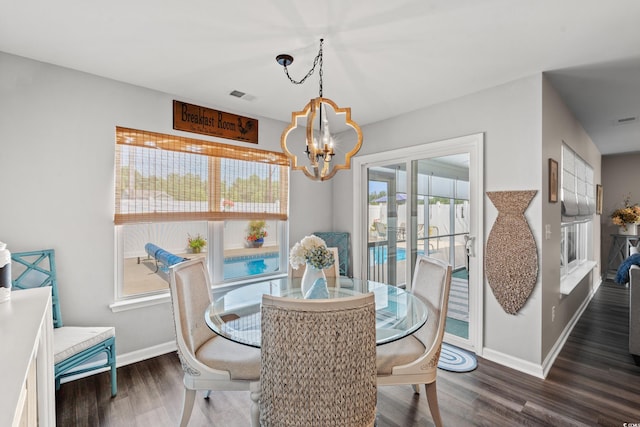 dining area featuring a notable chandelier and dark hardwood / wood-style floors