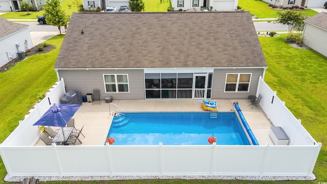 back of property with a patio, a fenced in pool, and central air condition unit