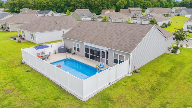 view of pool with a yard, a grill, and a patio area