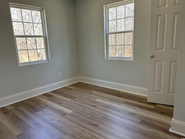 empty room featuring light wood-style flooring and baseboards