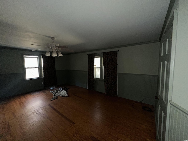 spare room with dark hardwood / wood-style flooring, ornamental molding, and ceiling fan