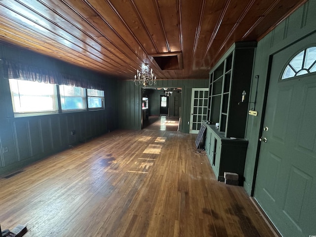 interior space with a notable chandelier, wood ceiling, and wood-type flooring