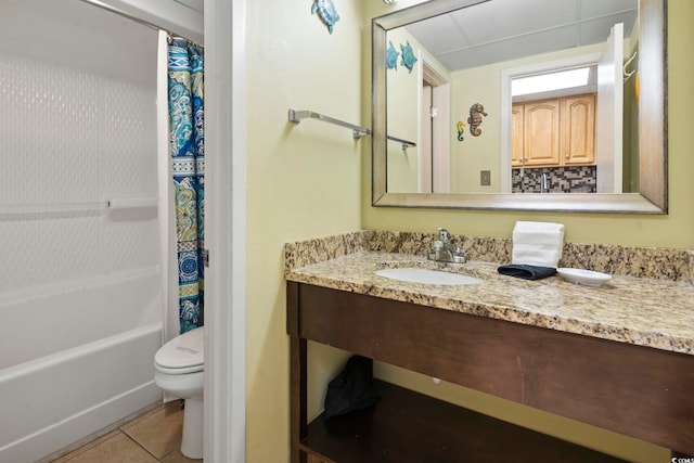 full bathroom with vanity, tile patterned floors, toilet, and shower / bath combo with shower curtain