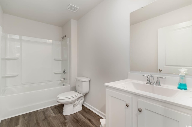 full bath with washtub / shower combination, vanity, toilet, visible vents, and wood finished floors
