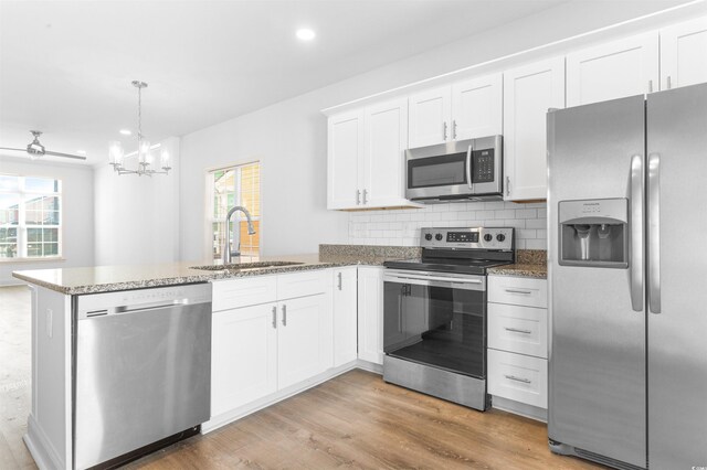 763 Moen Pl Unit 763-A, Myrtle Beach, SC 29577 - kitchen with stainless steel appliances, a sink, a peninsula, plenty of natural light, and recessed lighting