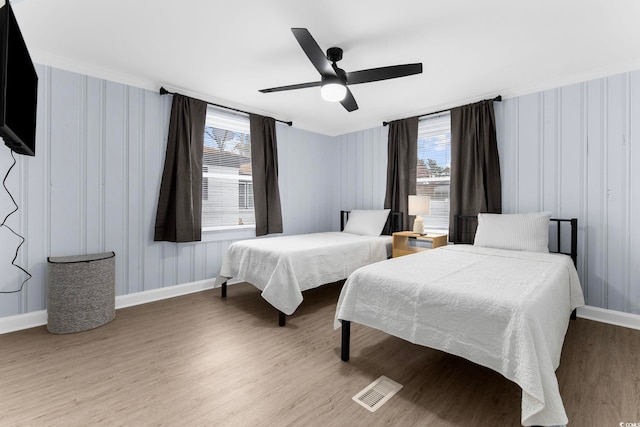 bedroom with wood-type flooring and ceiling fan